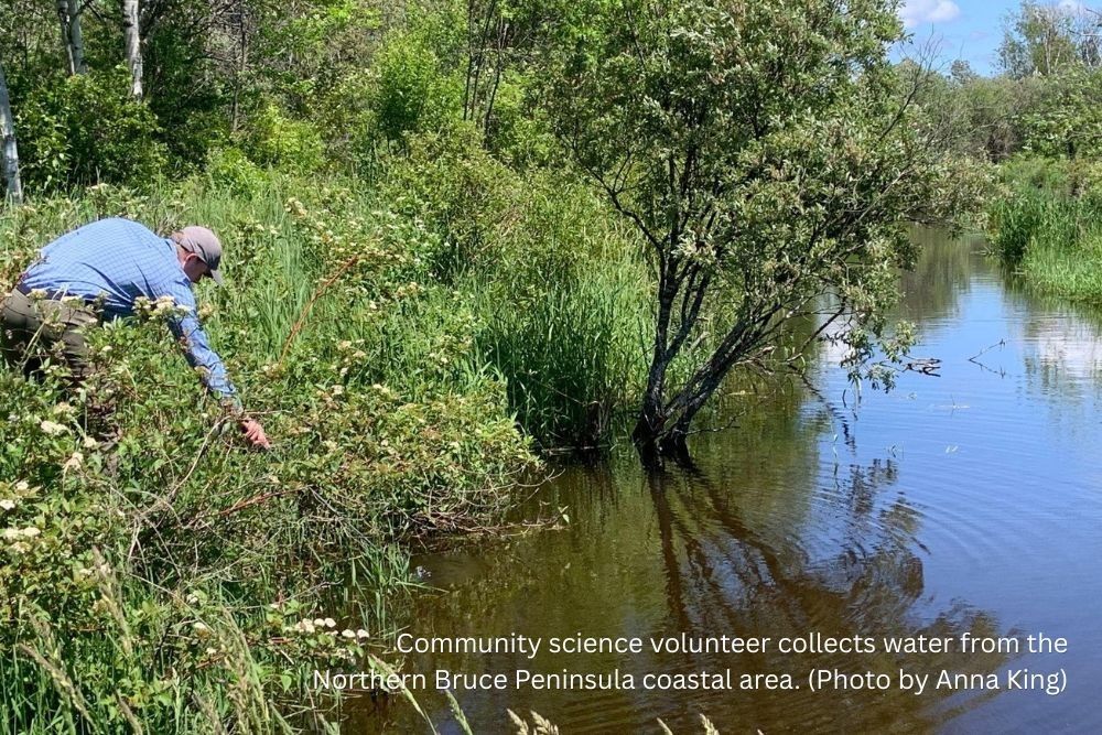 Community science volunteer collects water from the Northern Bruce Peninsula coastal area. (Photo by Anna King)
